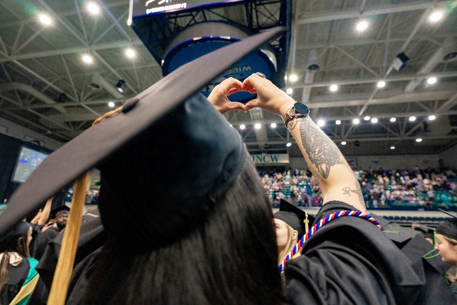 Graduating student wearing mortarboard seen from behind
