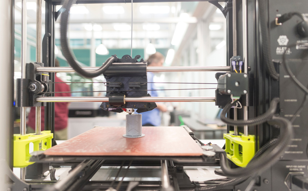 3D printer printing a gray object