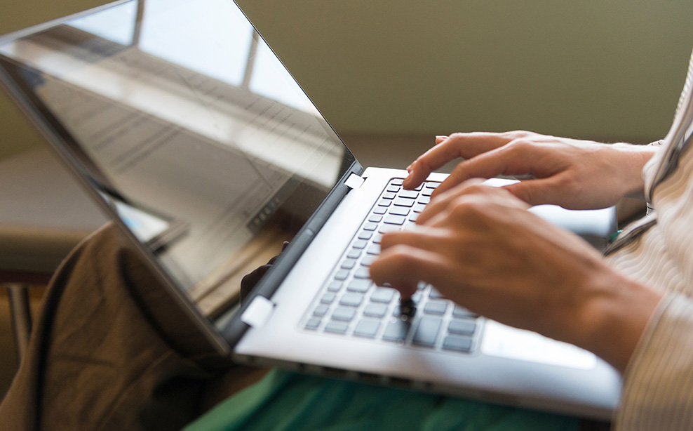 Typing on laptop