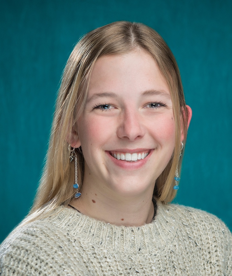 headshot of whitney formon. long blonde hair. green sweater. 