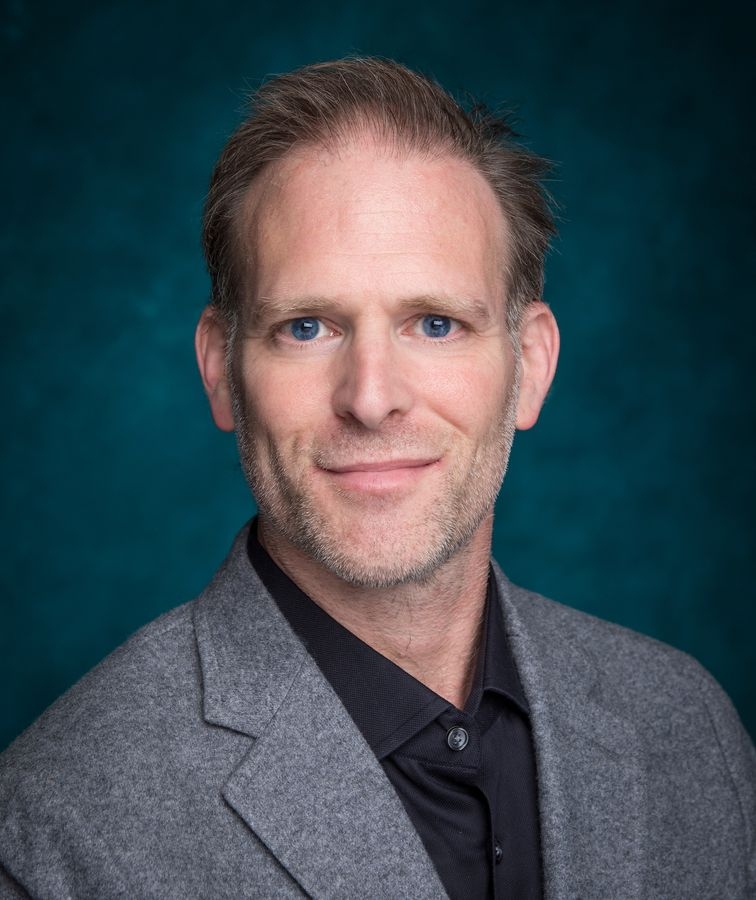 Male faculty member smiling in portrait