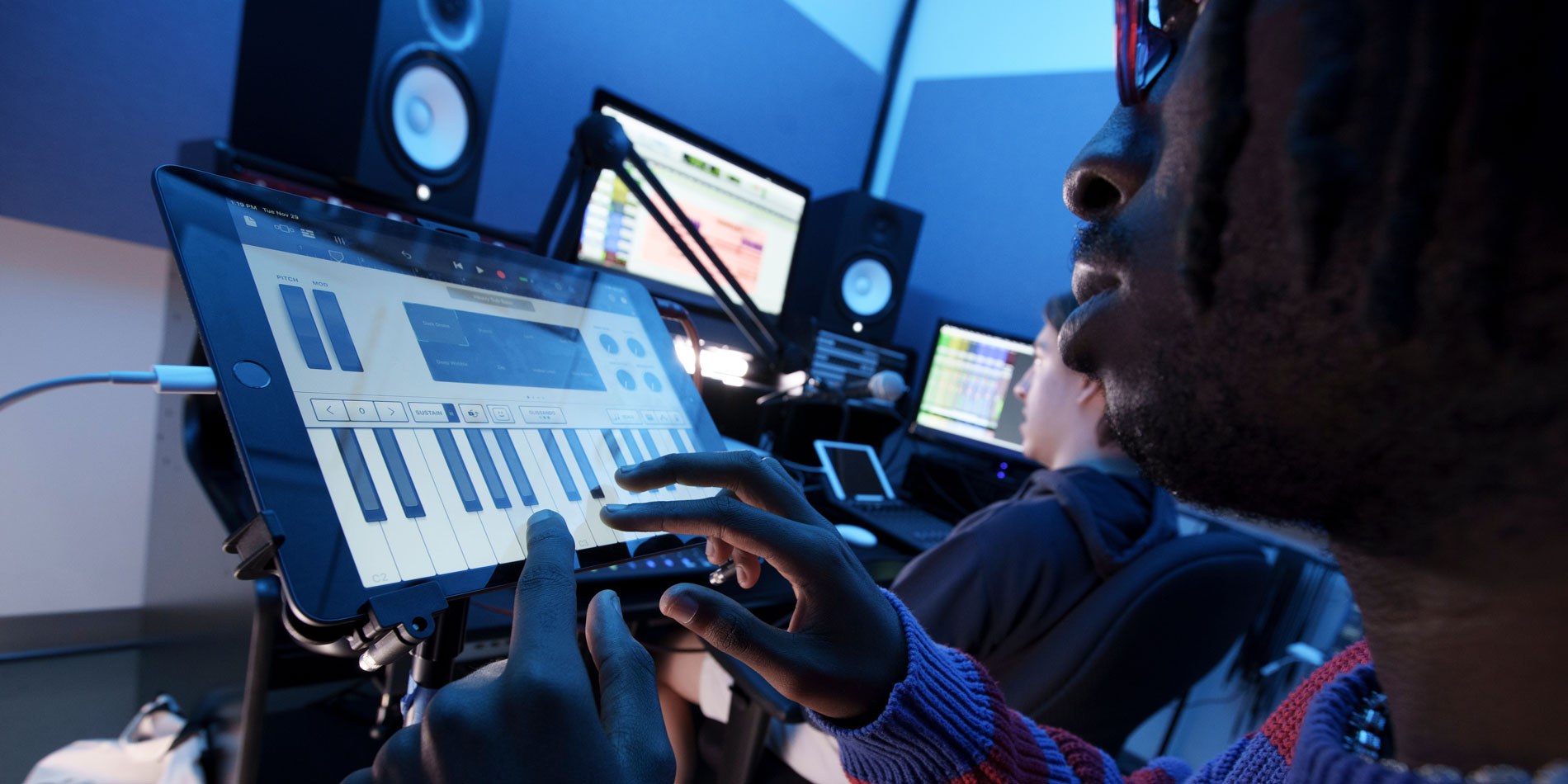Student recording music on ipad for music production class