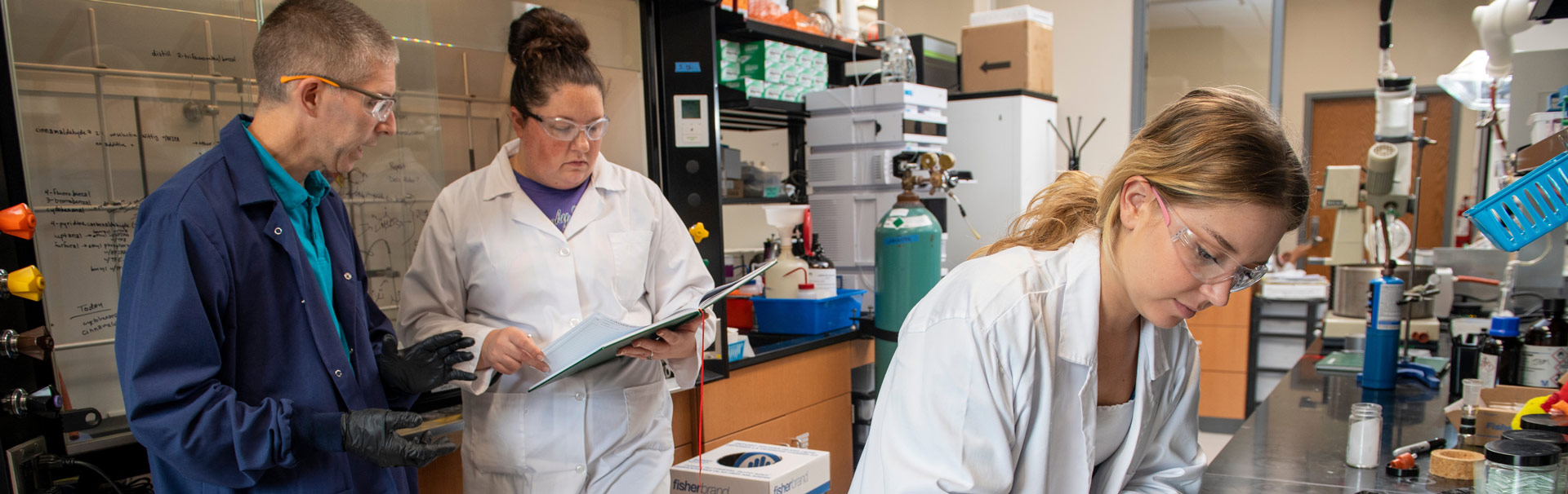 Lab students work with professor doing hands-on research