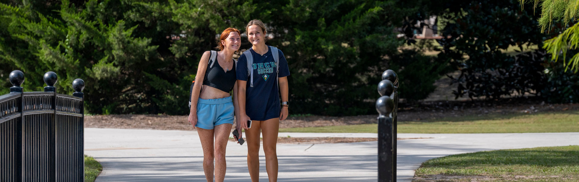 Students walking across a bridge on campus