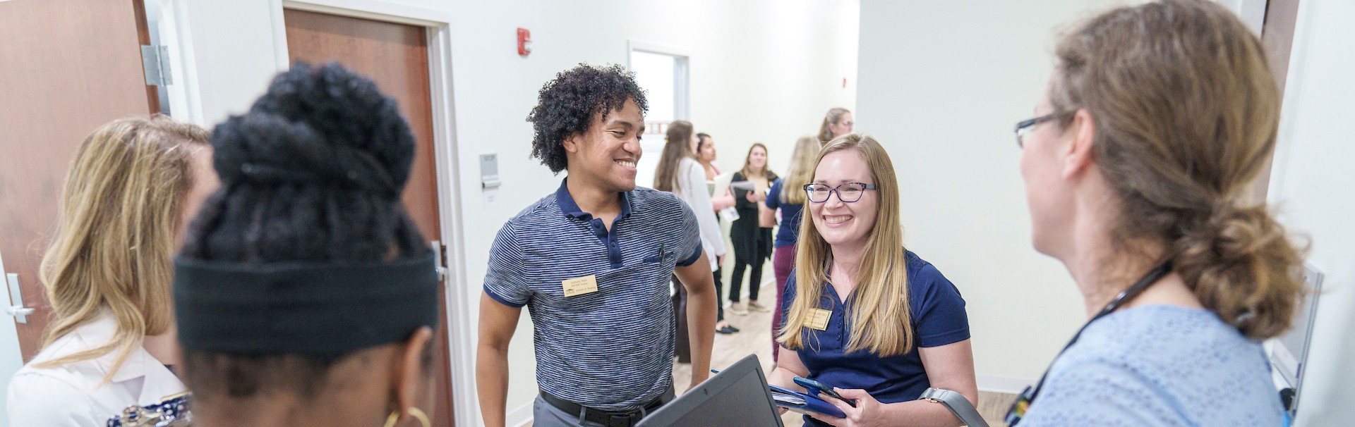 Nursing students talking in a hallway