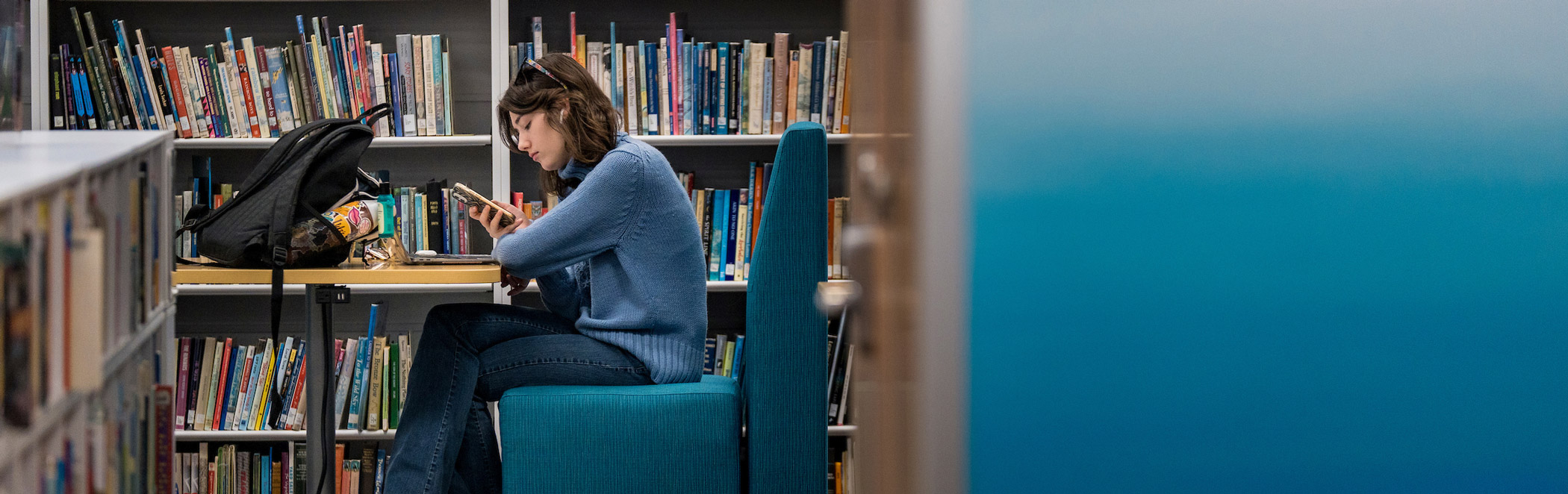 Female student in library reading
