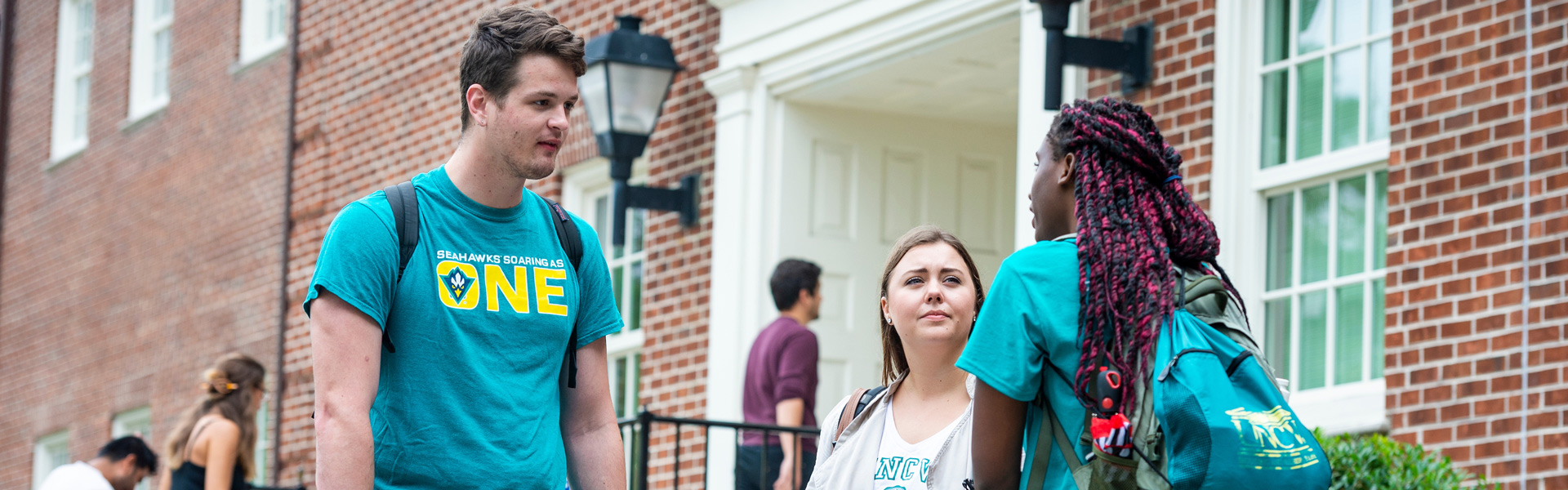Three students talking