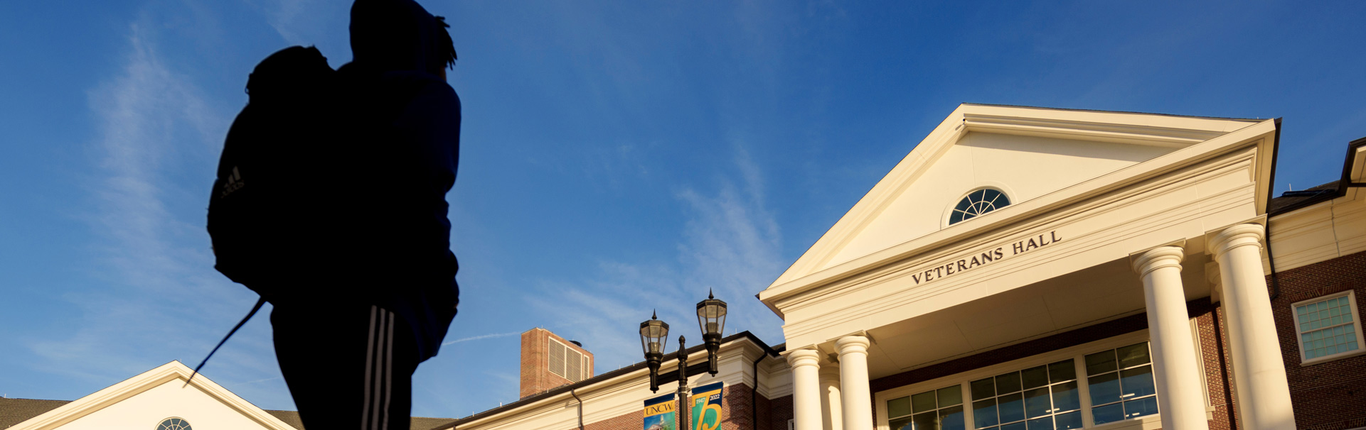 Students walking in front of UNCW's Veterans Hall