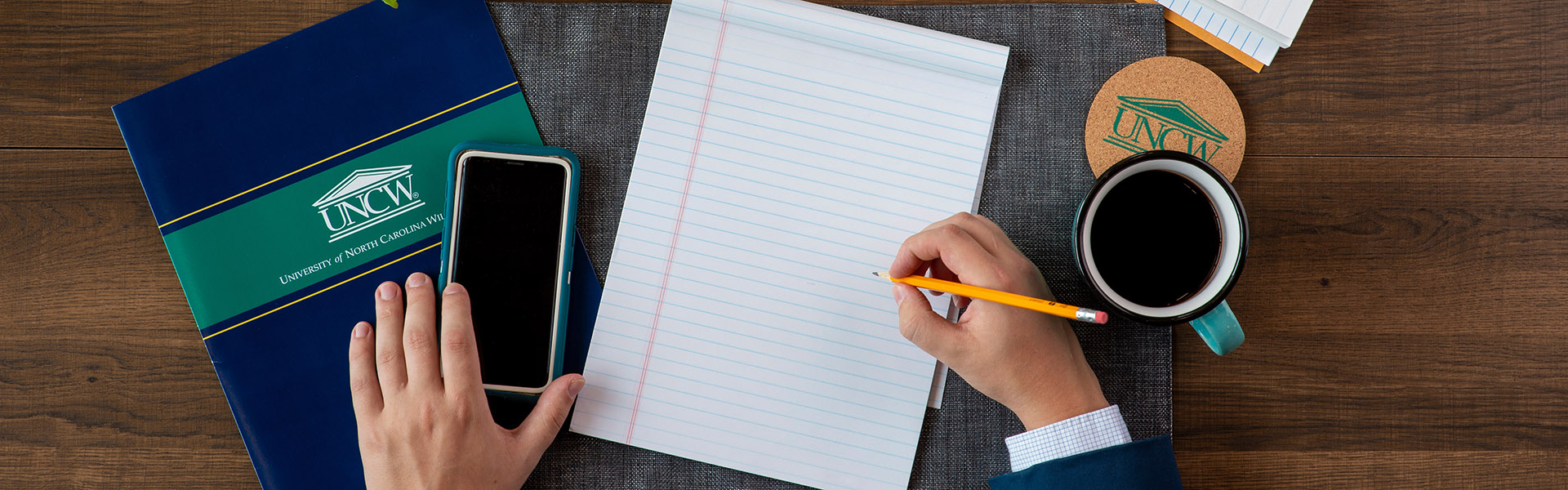 writing and holding phone