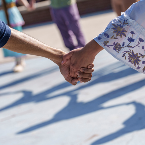 Two people holding hands