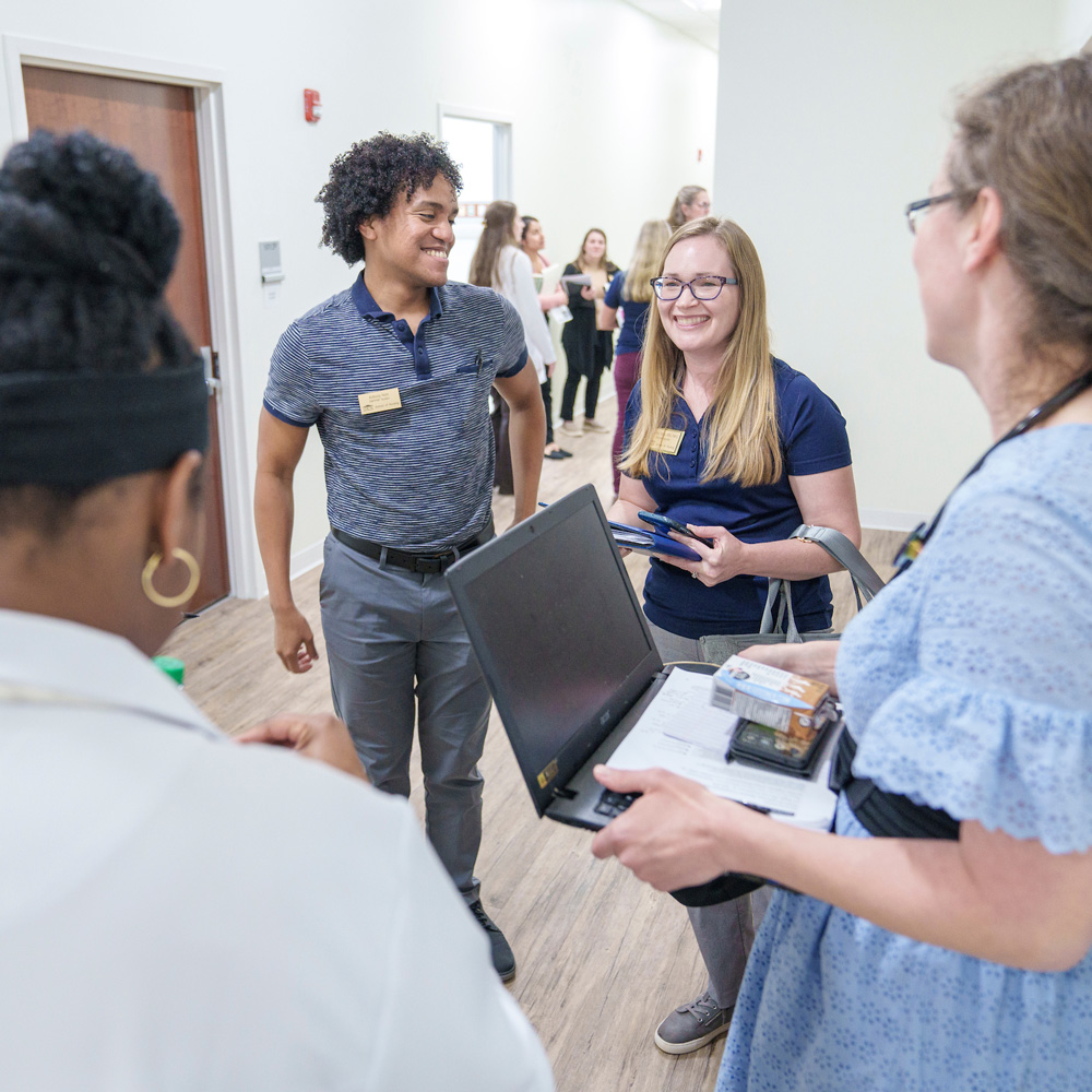 A student and preceptor stand in the hallway of a clinic