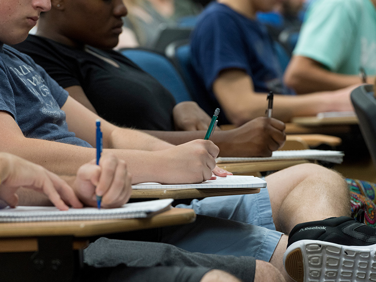 students take notes by hand in class