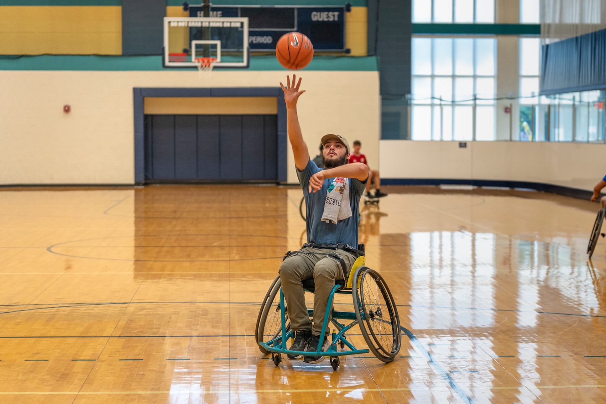 Guy in wheelchair shooting basketball