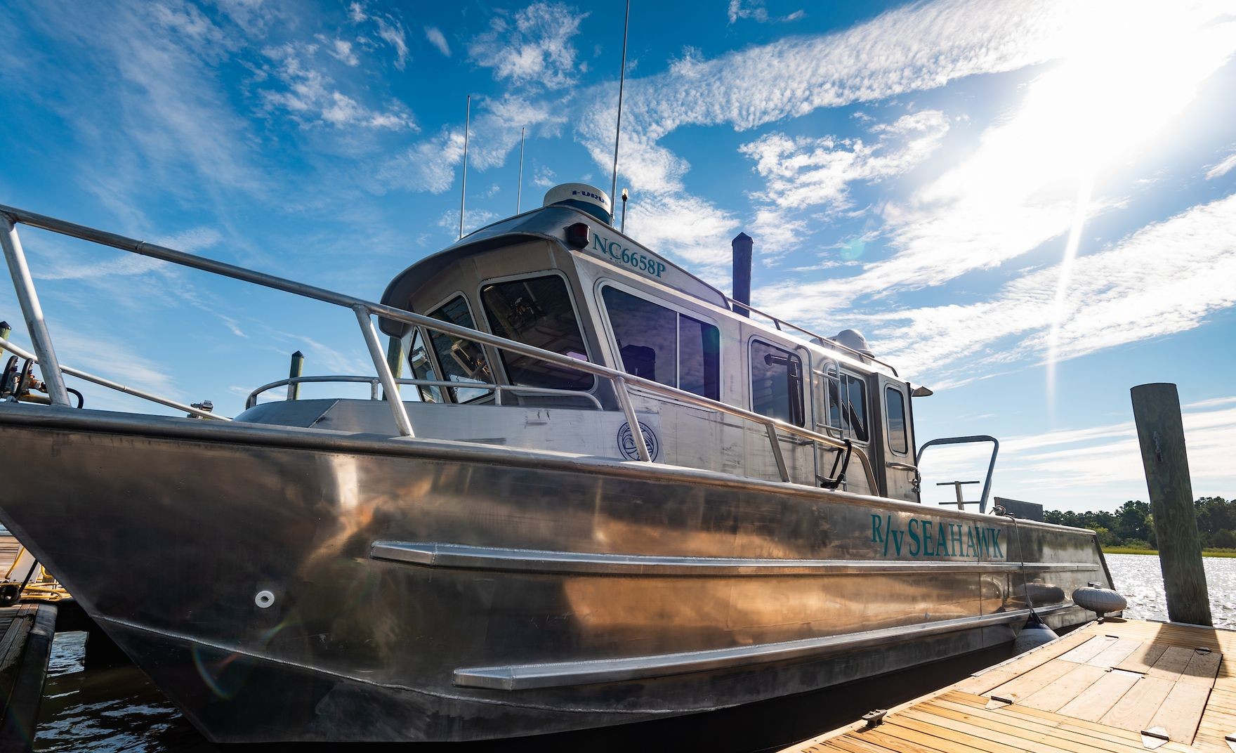 R/V Seahawk silver metal boat at a dock
