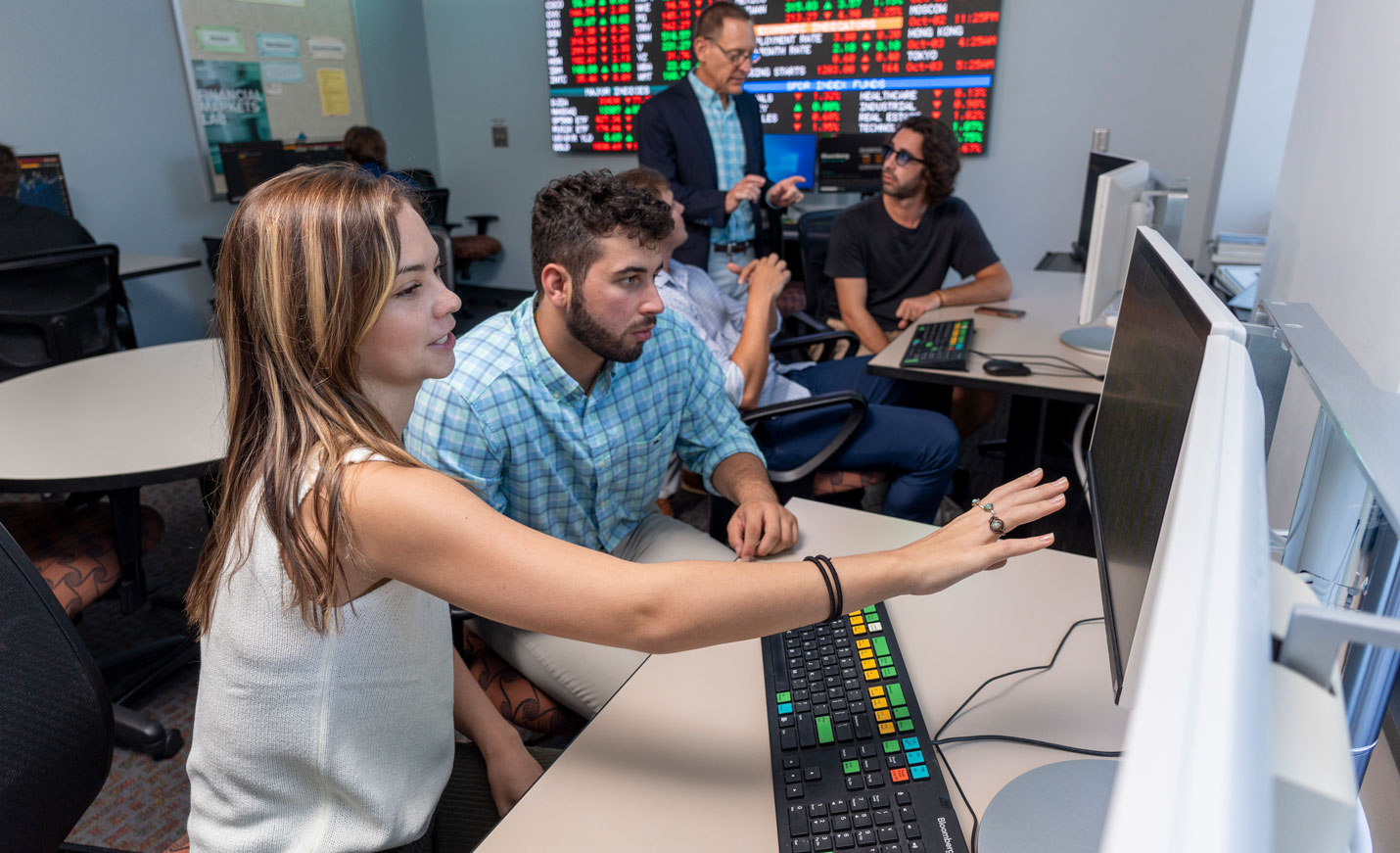 People gathered studying stocks