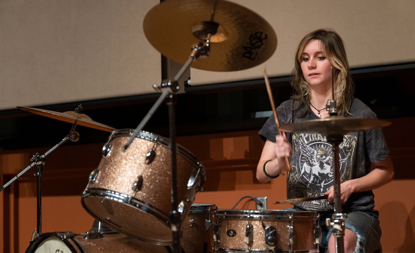 Student Practicing Drums at Rehearsal