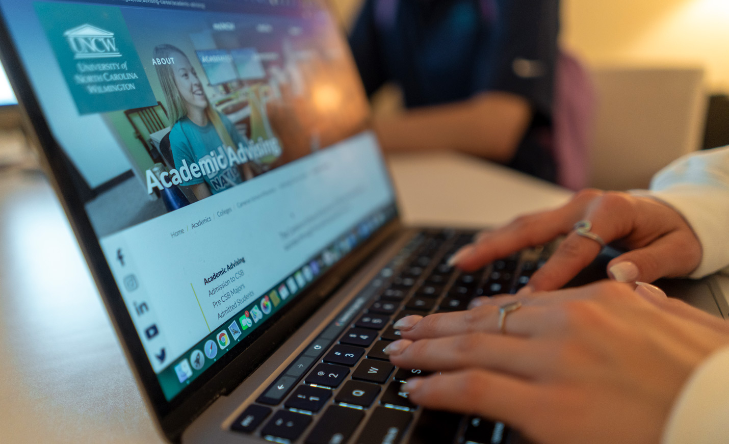Hands typing on a computer