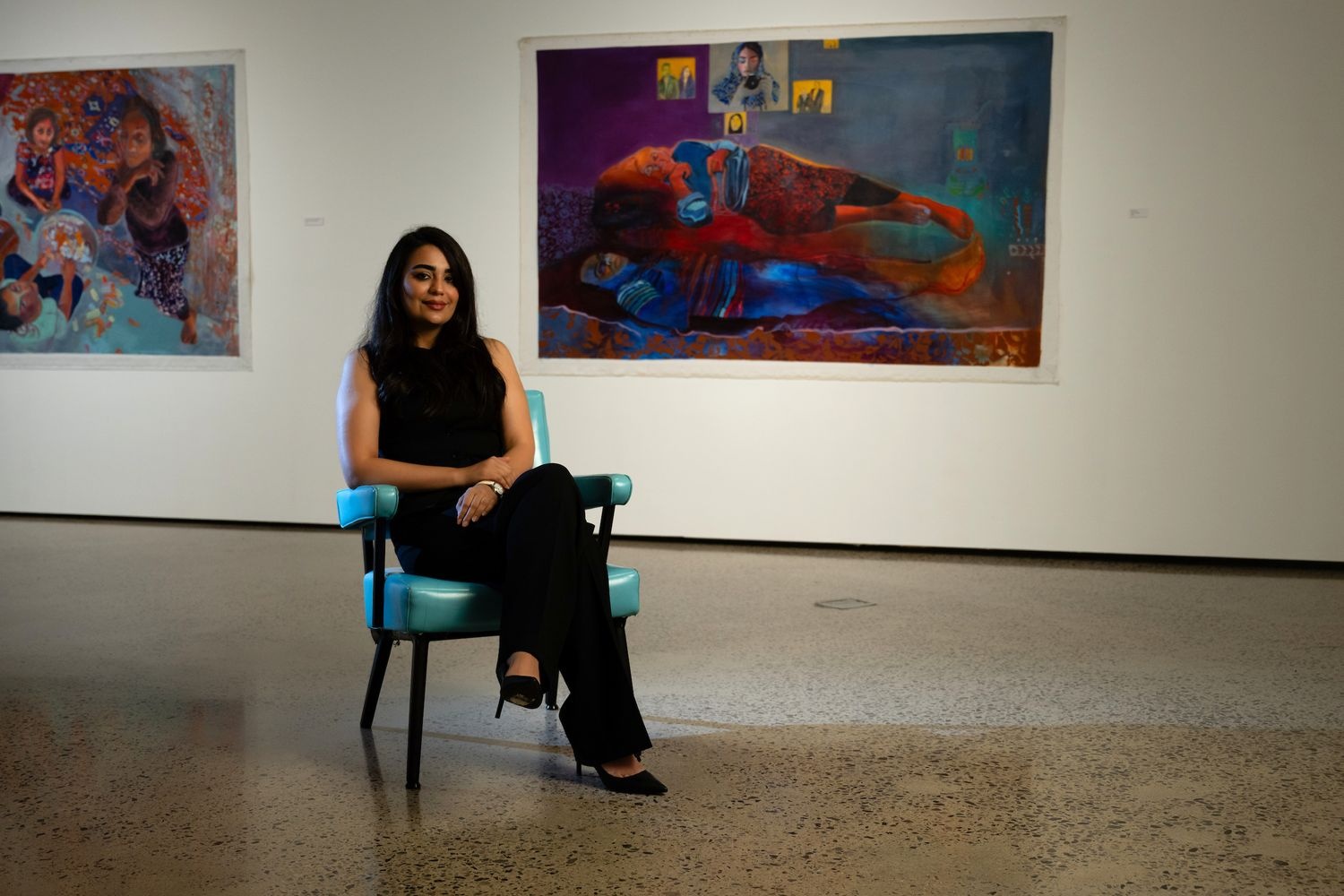 Shabnam Jannesari sits amid her colorful paintings