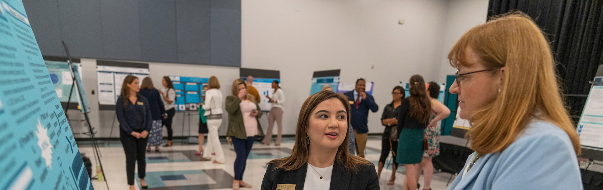 A DNP (Doctor of Nursing Practice) student presents her research project to a faculty member on the DNP Project Presentation Day.