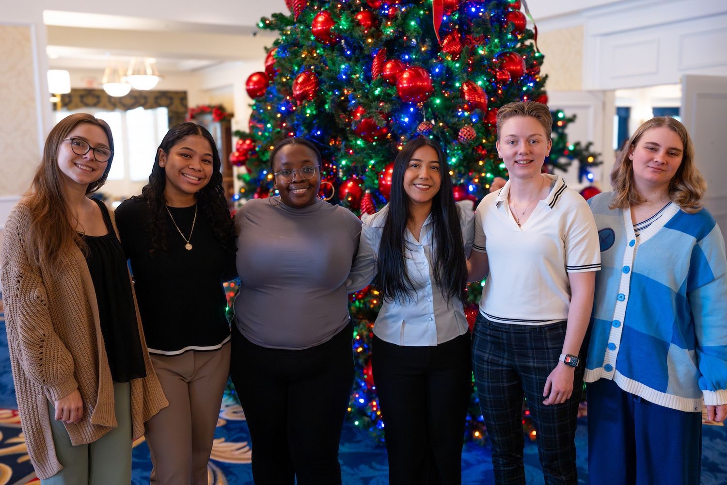 Next Step Adviser posing next to a Christmas tree