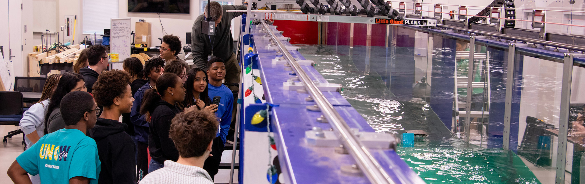 Students watching the boat race in the wave flumes simulator at UNCW