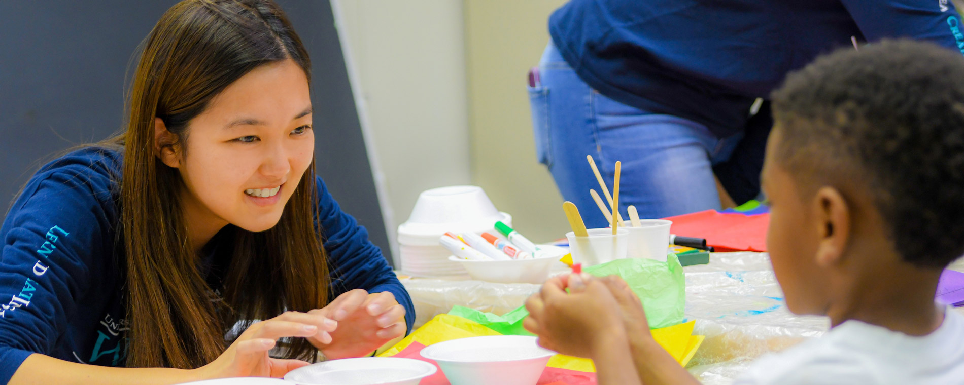 Student helps with art project