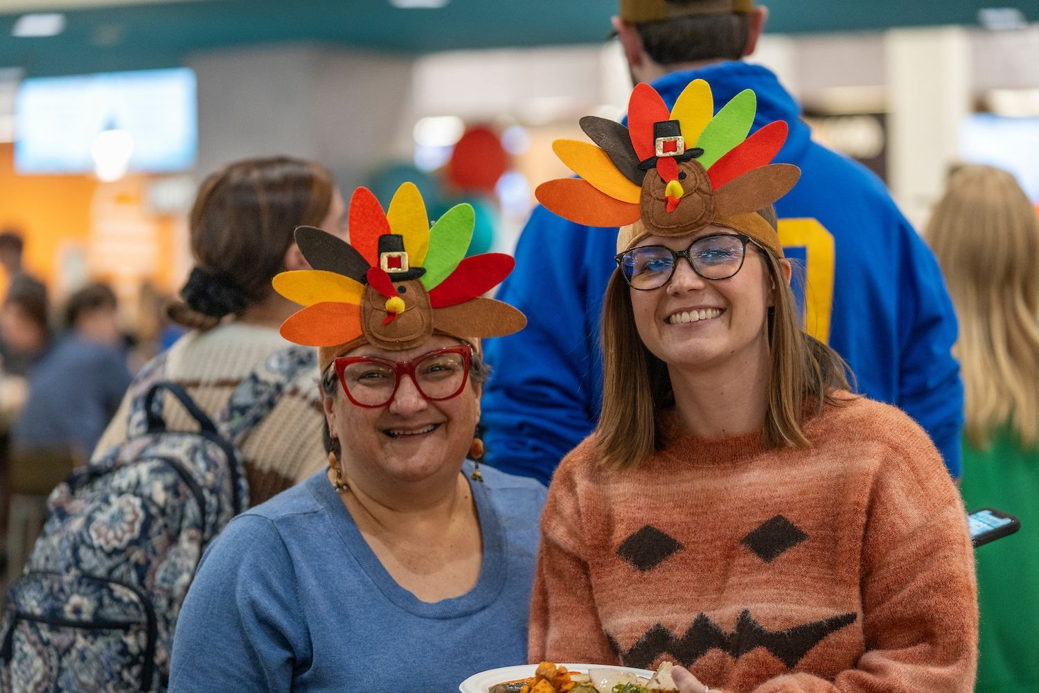Women wear turkey headwear at Wagsgiving at Wagoner Dining Hall
