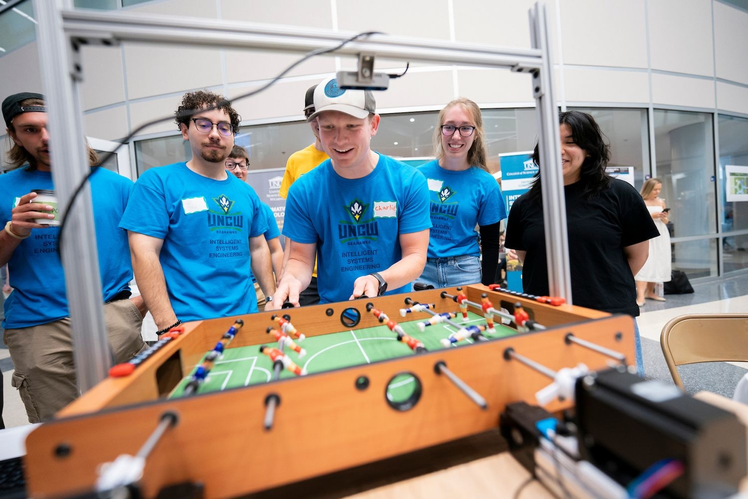 Person playing against a robot in table football