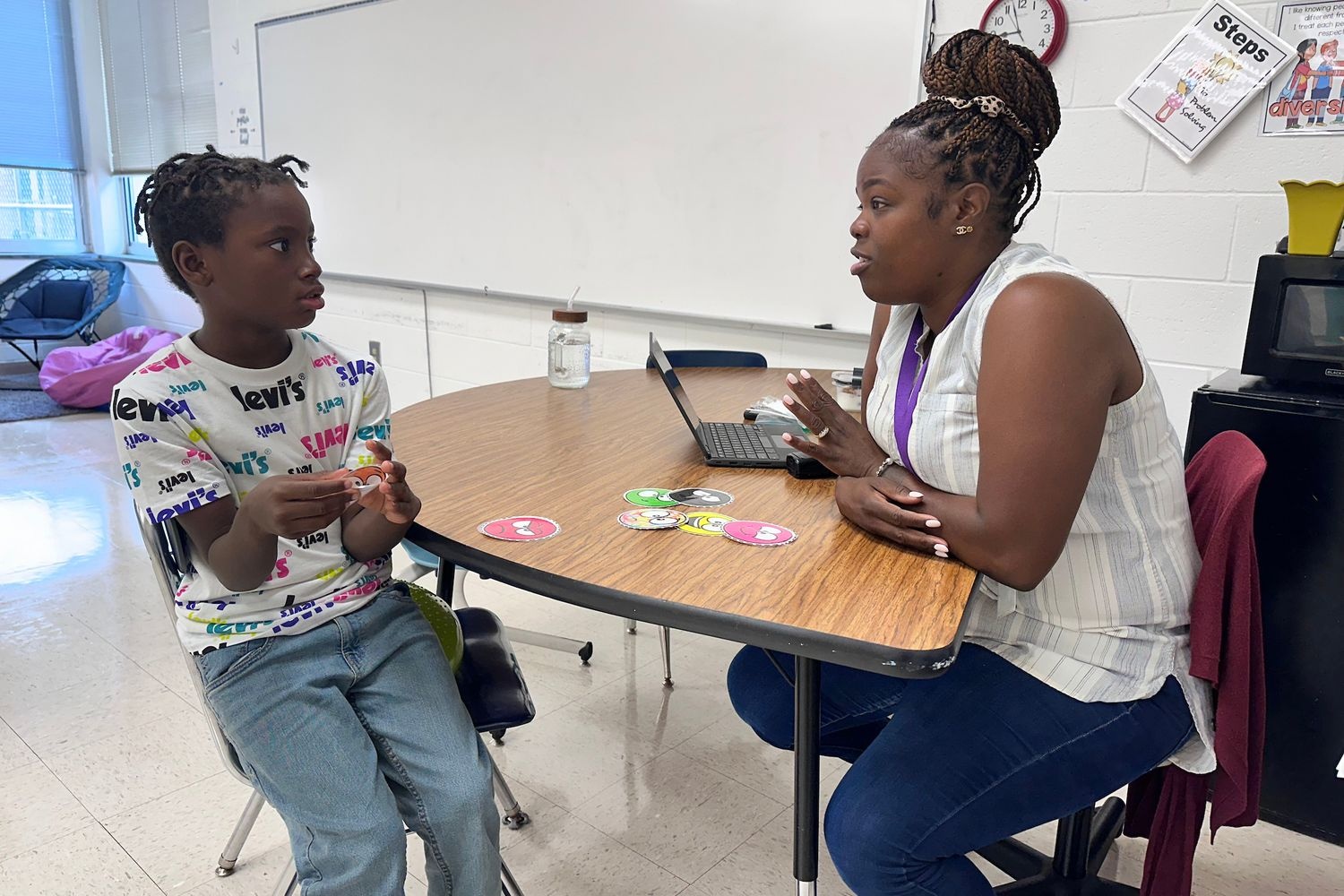 Student working with counselor at table
