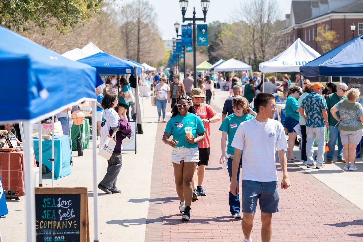 Students walk around the 3rd Annual Be Kind to Your Mind Mental Health Awareness Festival hosted by School of Social Work down Chancellor's Walk on campus.