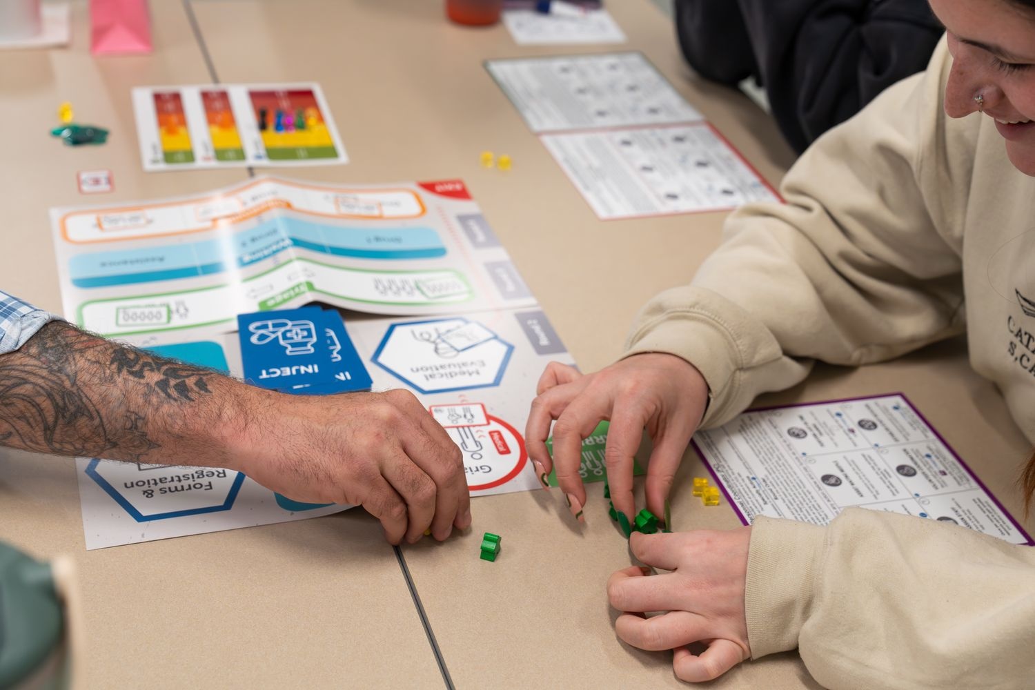 UNCW Students set up the pieces to play the TEST POD (Point of Distribution) Edition. A training and exercise simulation designed to help participants understand specific roles and responsibilities at a POD during a public health emergency. 
