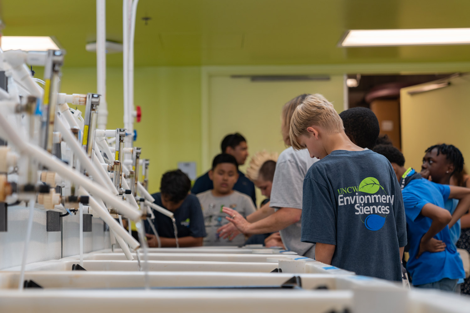 A youth class of students wearing Environmental Sciences shirts