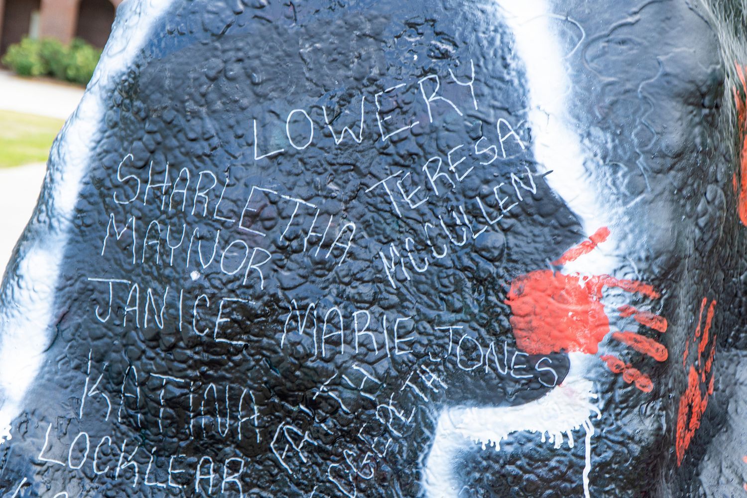 A painting in black and red memorializing missing and murdered Indigenous women