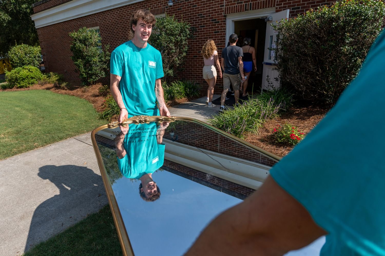 Students helping other students move in to a residence hall.