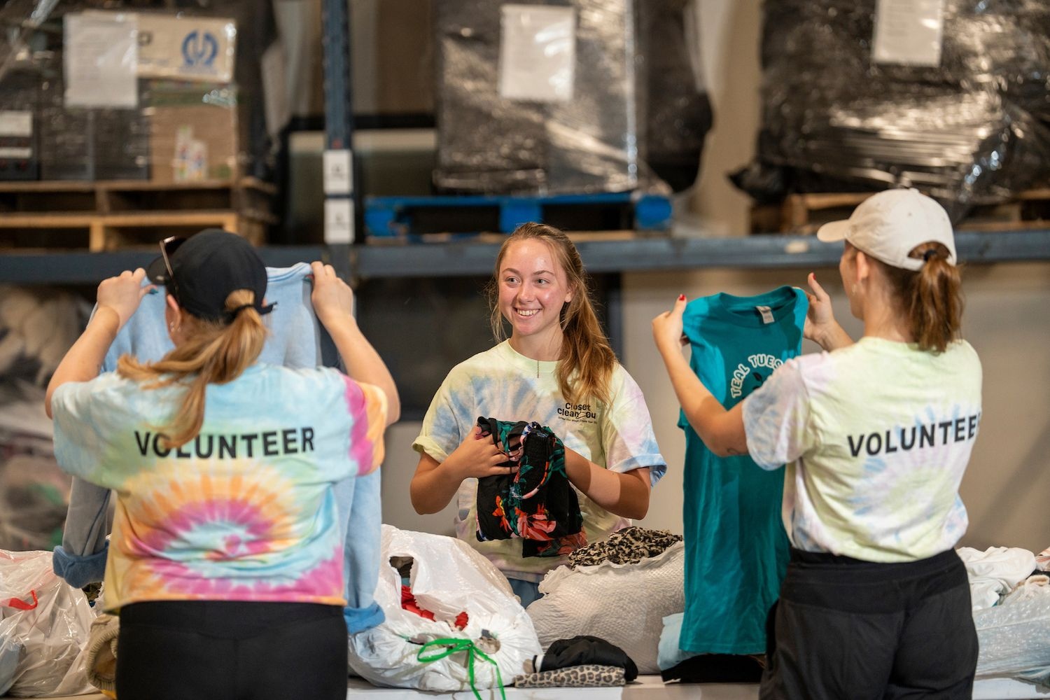 students folding and sorting donated clothes