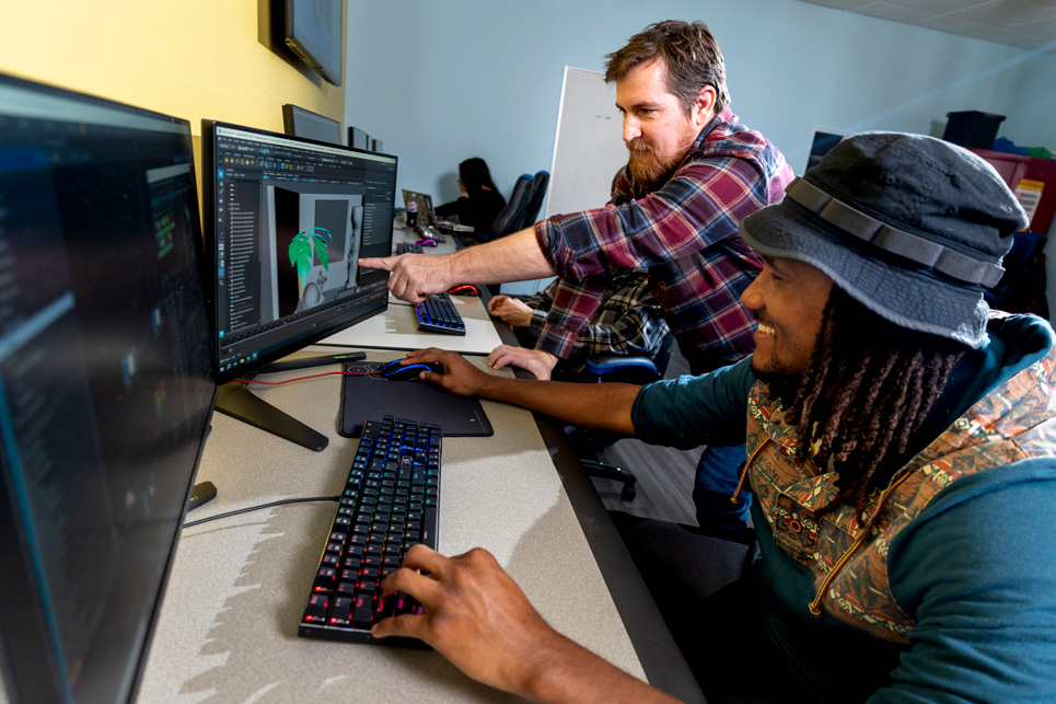 Teacher looking at student's 3D model project