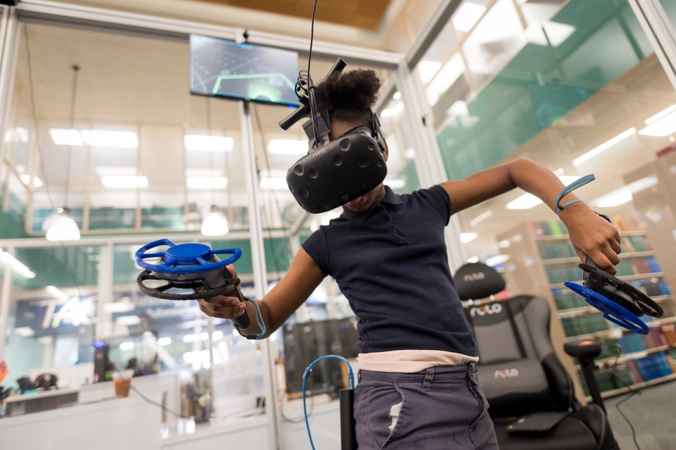 kid with virtual gaming headset on waving arms
