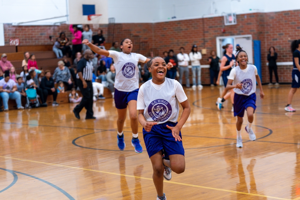 3 girls jumping with excitement for basketball