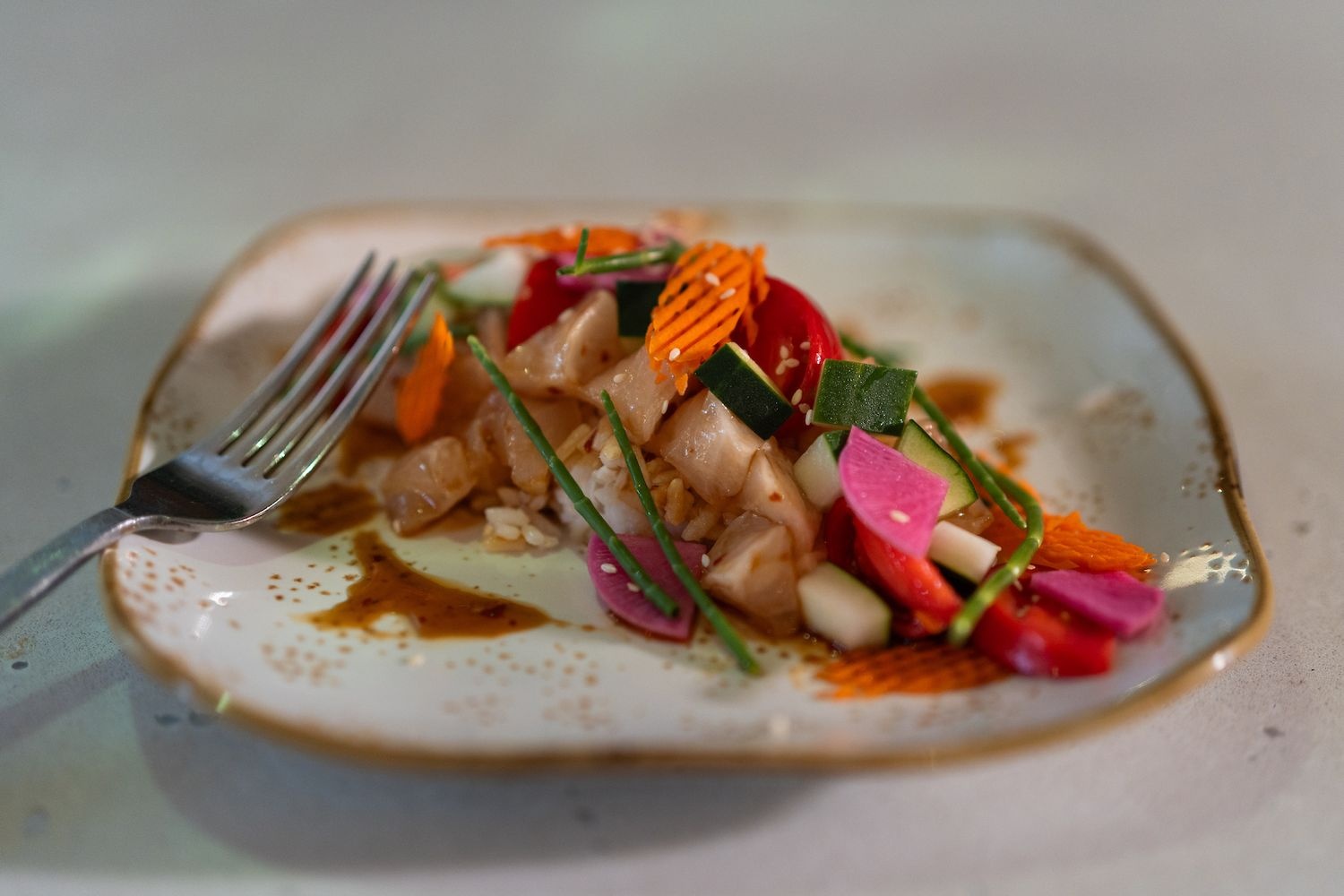 A colorful black sea bass dish served on a plate
