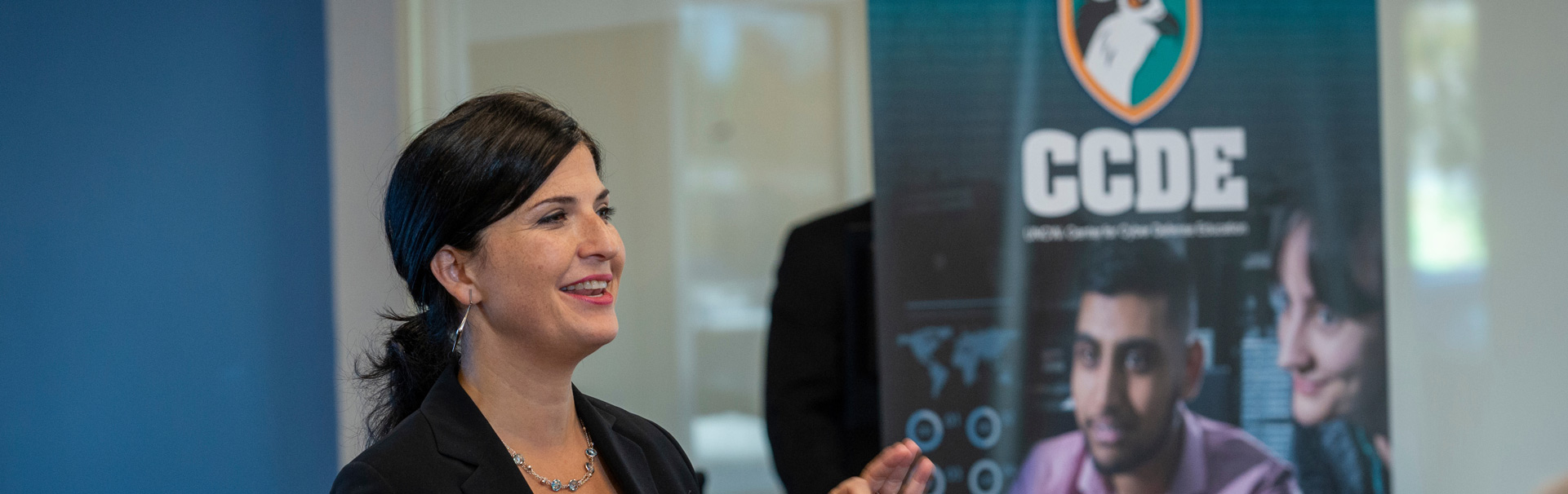 Woman presenting at a cyber defense workshop