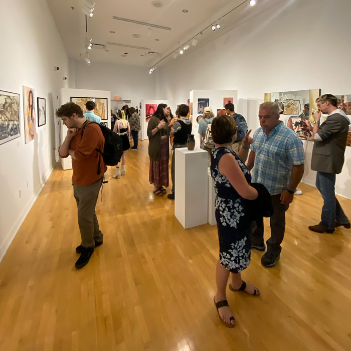 Patrons looking at art in the CAB Art Gallery
