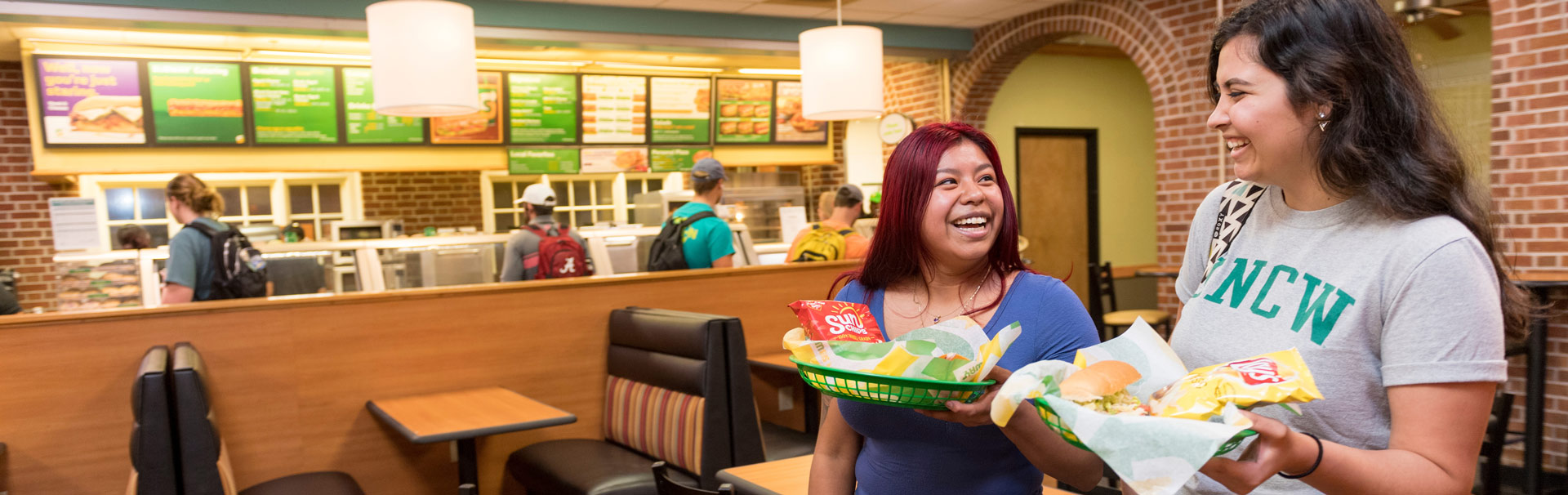  Students carrying food at a dining hall