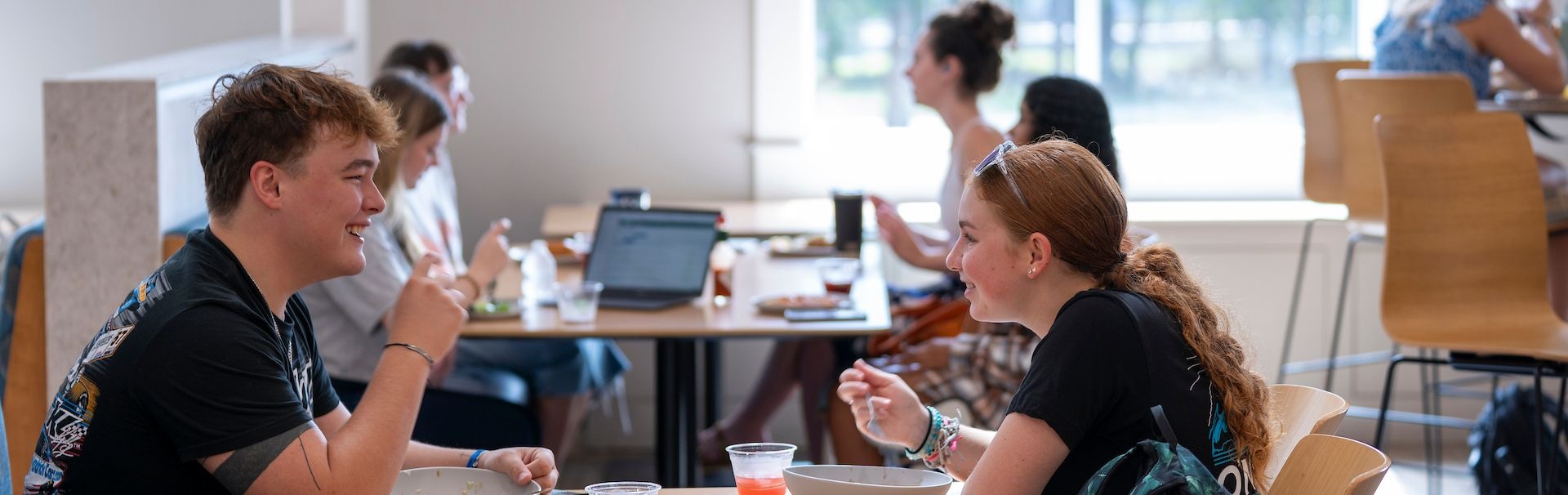 groups of students sitting at a table eating at the Shore Dining hall