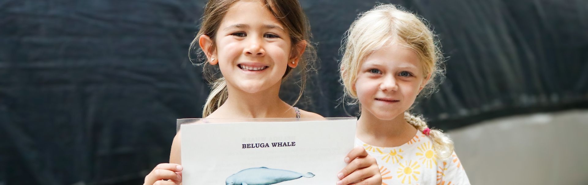 Children holding image of Beluga Whale