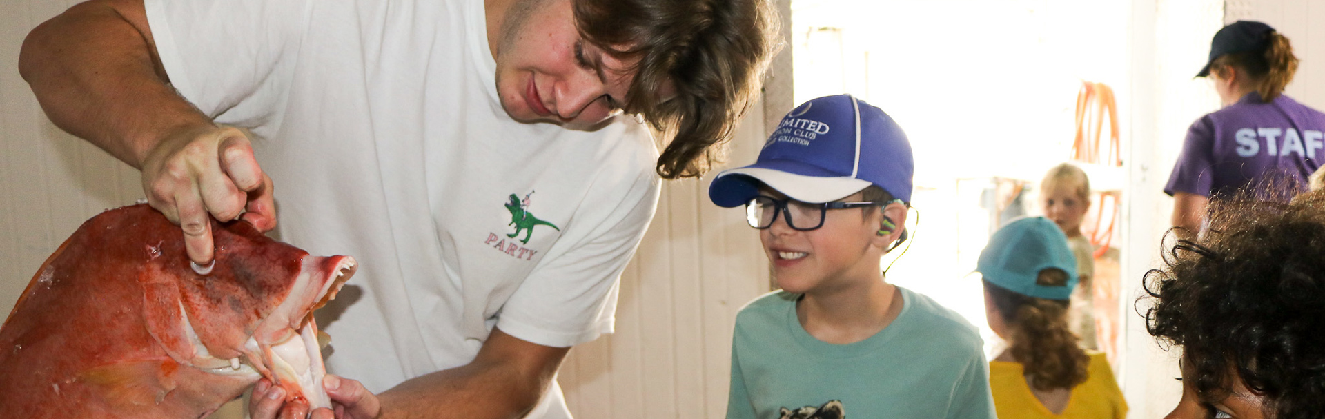 Student shows youth a red fish