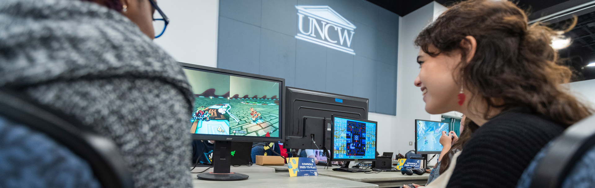 Student playing video game showing excitement