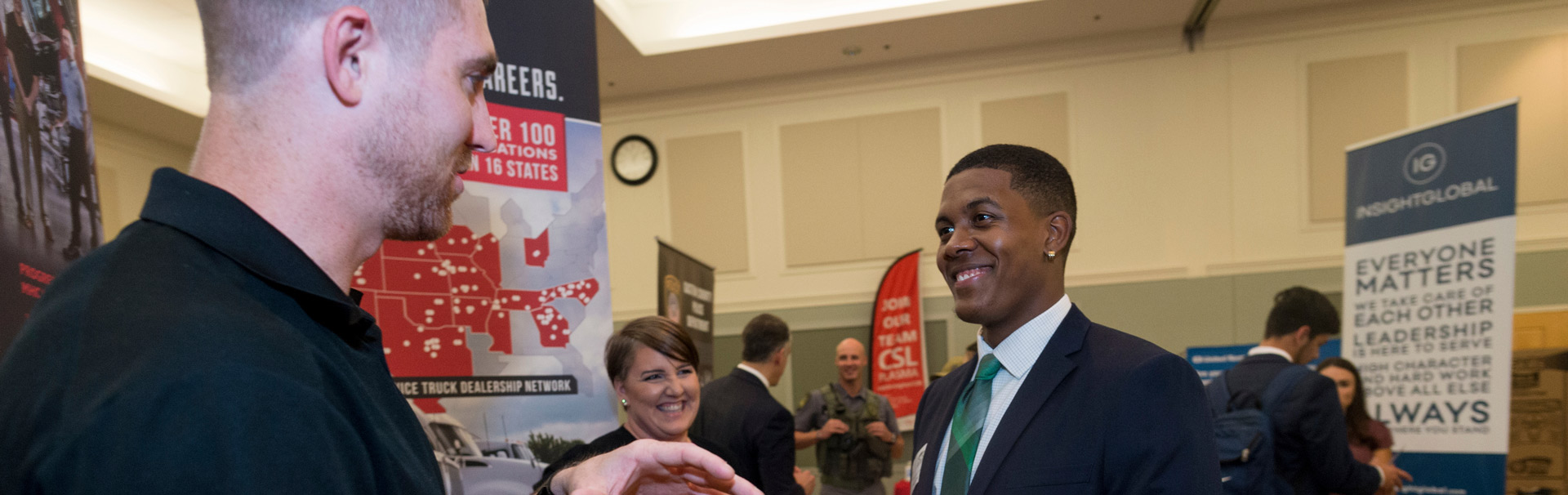  A student talks with one of the employers recruiting at a job fair at UNCW